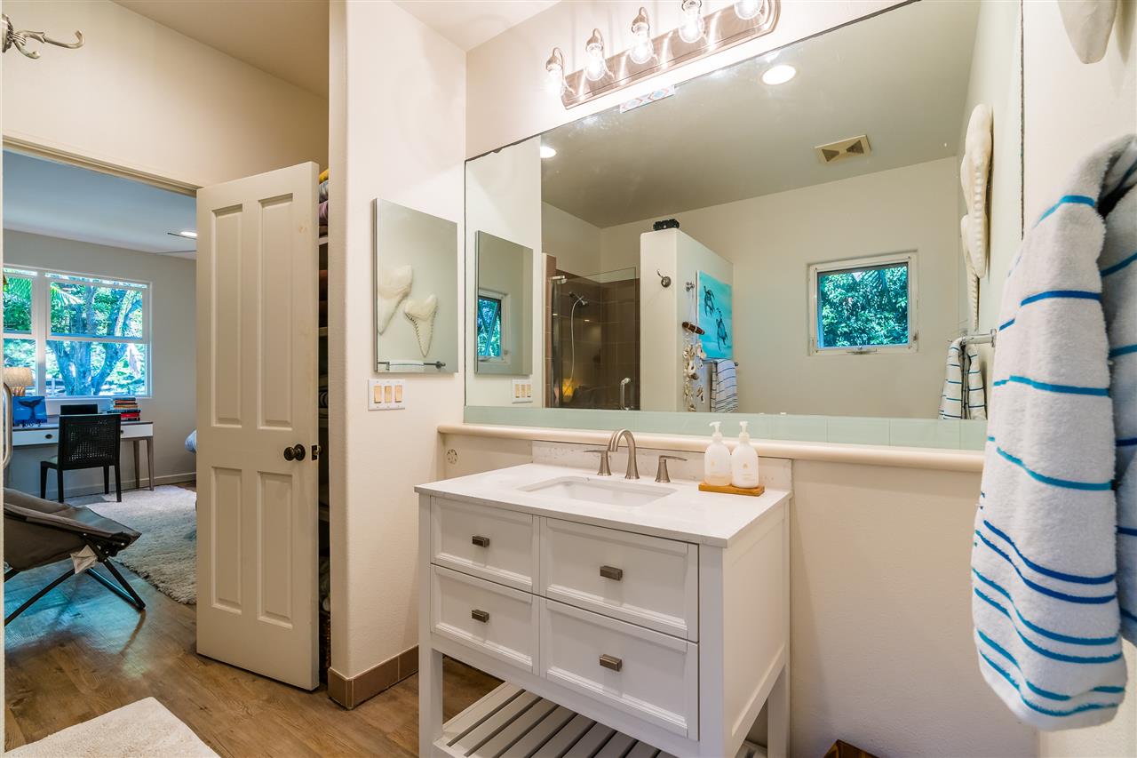 100 Laenani Street Haiku, HI 96708 - Photo 17 of 30 a bathroom with a sink a mirror and a shower