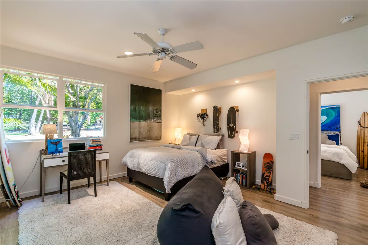 100 Laenani Street Haiku, HI 96708 - Photo 18 of 30 a bedroom with two beds and a large window