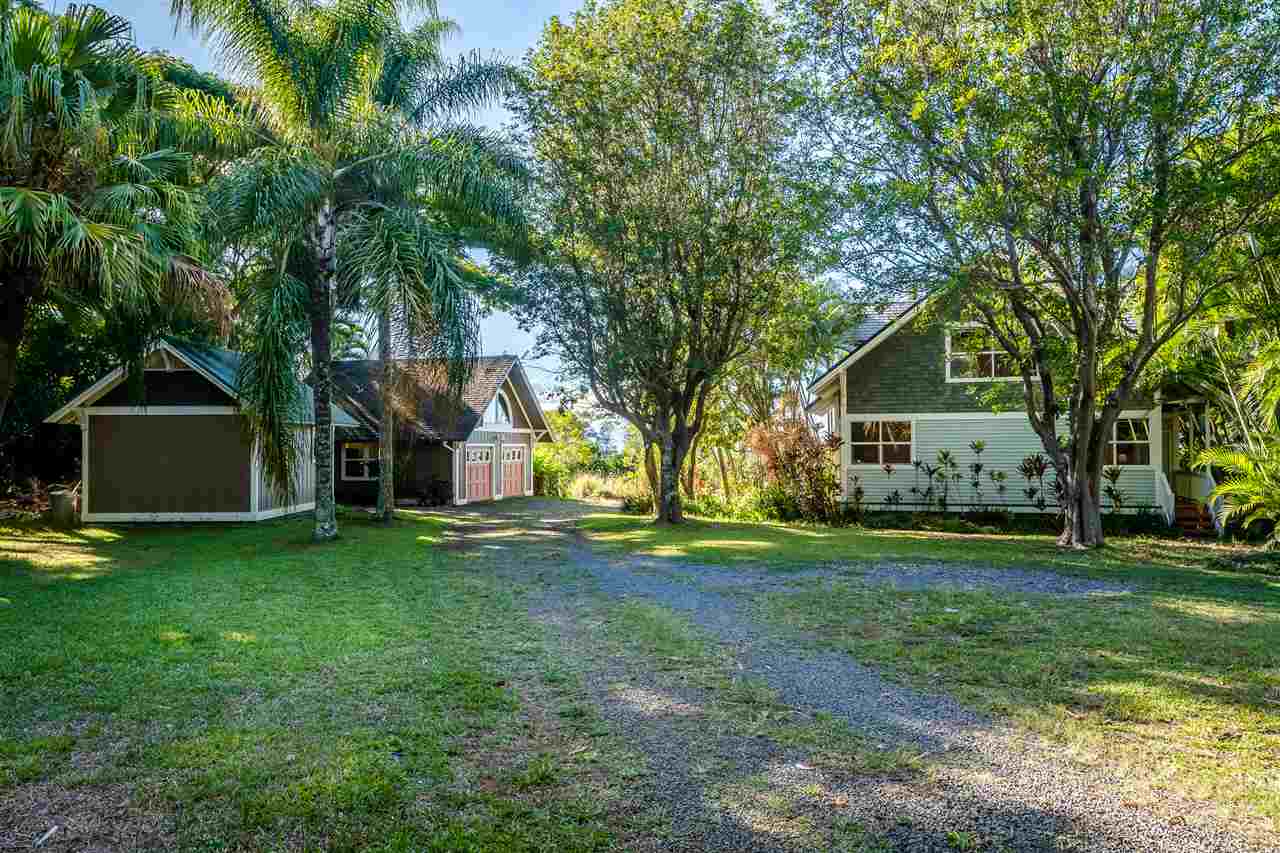 100 Laenani Street Haiku, HI 96708 - Photo 4 of 30 a front view of a house with a yard and trees