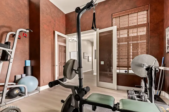 a view of a city from a dining room with furniture and a floor to ceiling window