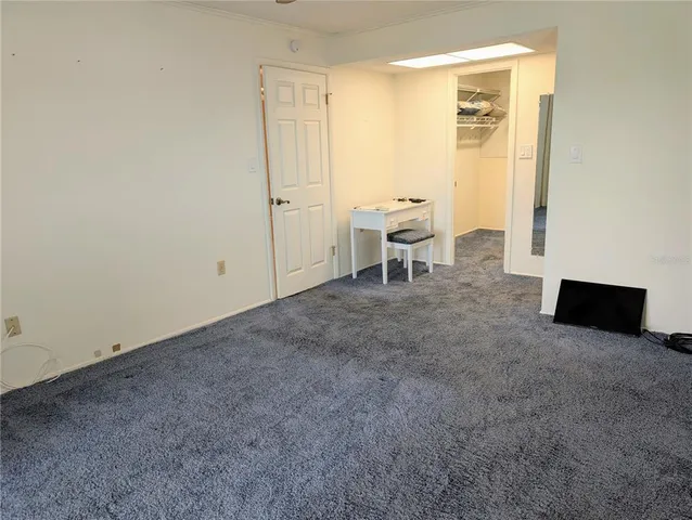 a view of a room with a table and chairs