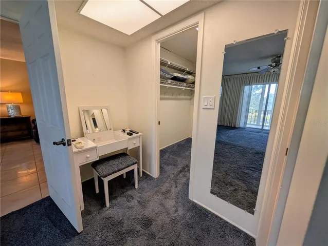 a view of a hallway to rooms and stairs