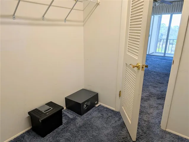 a view of a room with wooden floor and windows