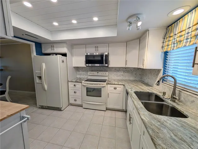 a kitchen with a refrigerator sink and microwave