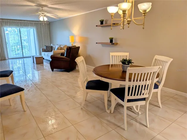 a dining room with furniture and chandelier kitchen view