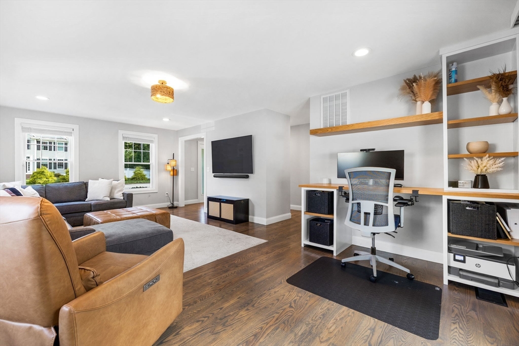 138 Dedham Street Canton, MA 02021 - Photo 15 of 41 a living room with furniture and a flat screen tv with kitchen view