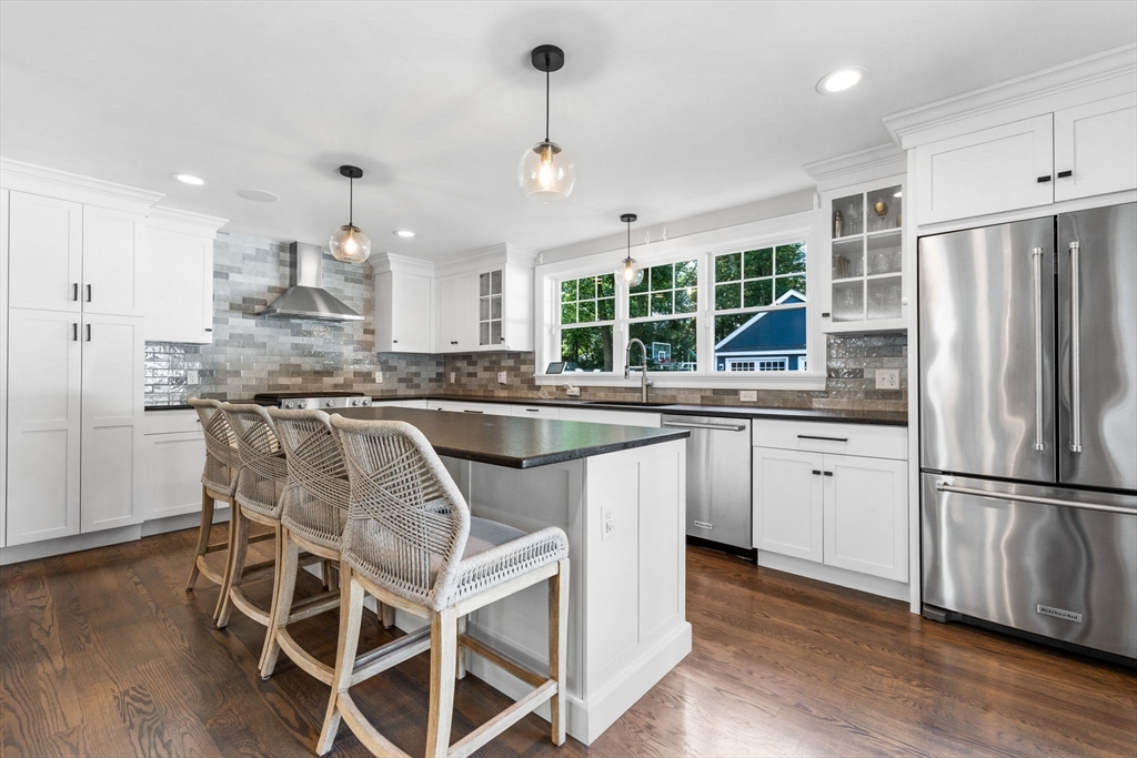 138 Dedham Street Canton, MA 02021 - Photo 2 of 41 a kitchen with stainless steel appliances granite countertop a refrigerator a sink dishwasher a stove and white cabinets with wooden floor