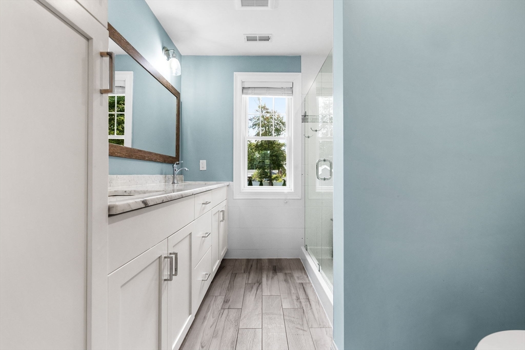 138 Dedham Street Canton, MA 02021 - Photo 21 of 41 a bathroom with a sink a mirror and a toilet