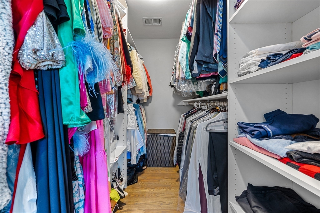 138 Dedham Street Canton, MA 02021 - Photo 24 of 41 a view of walk in closet with clothes and shoes