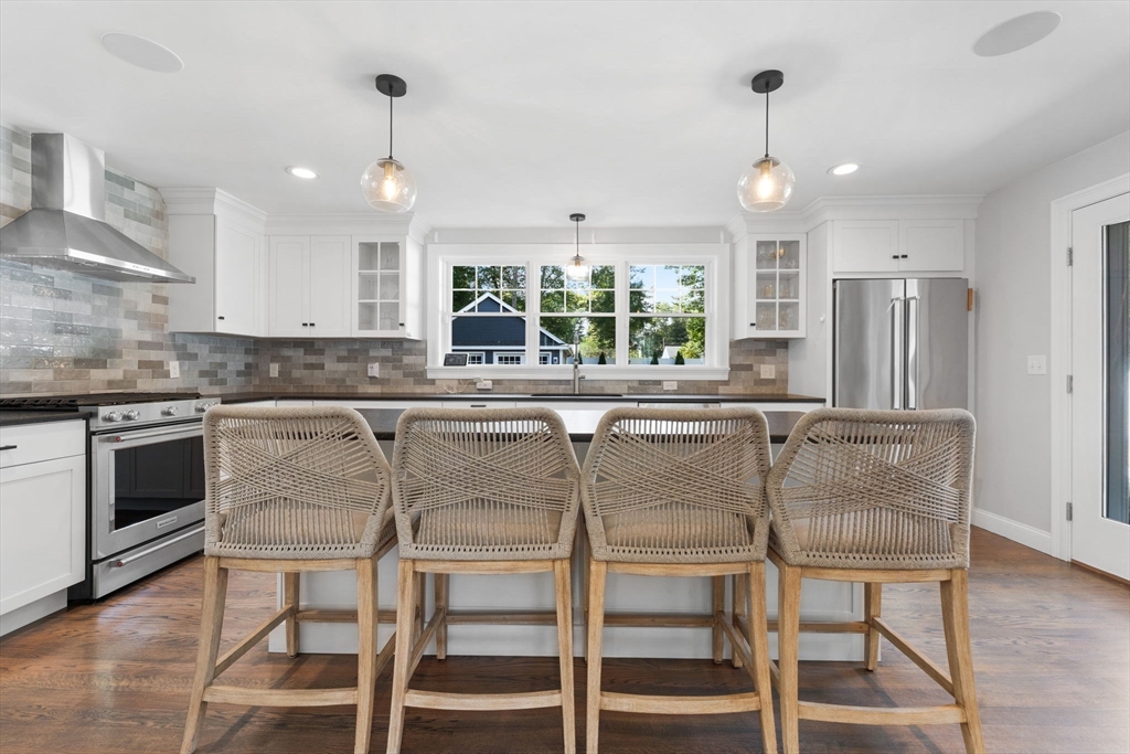 138 Dedham Street Canton, MA 02021 - Photo 3 of 41 a kitchen with stainless steel appliances granite countertop a stove top oven and a refrigerator