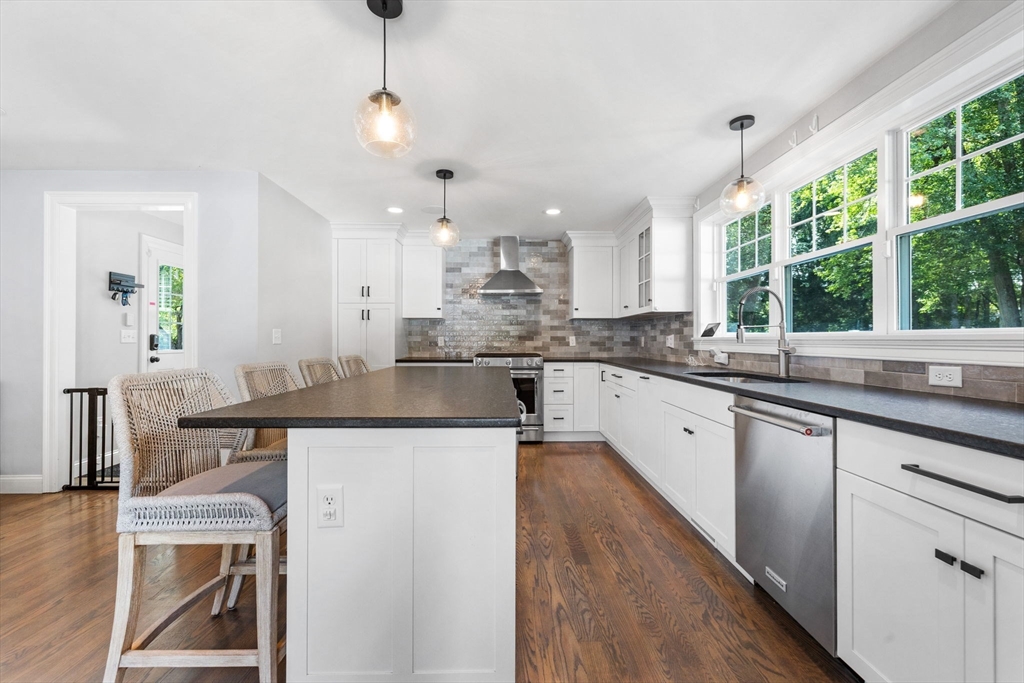 138 Dedham Street Canton, MA 02021 - Photo 6 of 41 a kitchen with kitchen island a sink table and chairs