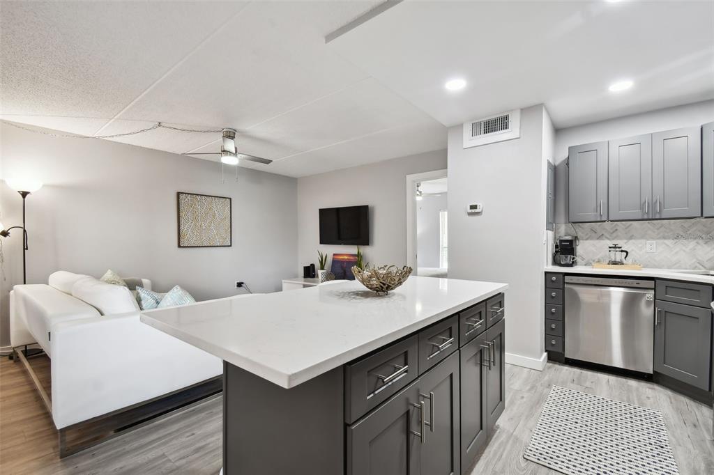 8901 Blind Pass Road, Unit 228 St. Pete Beach, FL 33706 - Photo 14 of 29 a kitchen with a sink cabinets and wooden floor