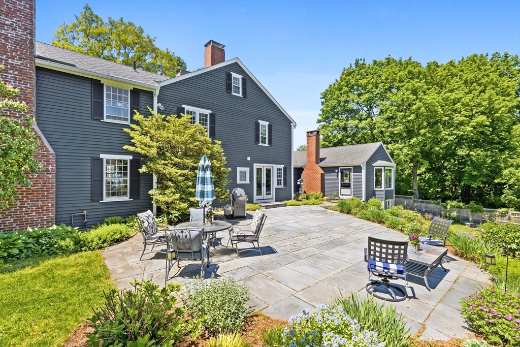 22 Stinson Road Andover, MA 01810 - Photo 2 of 40 a view of a patio with table and chairs and potted plants