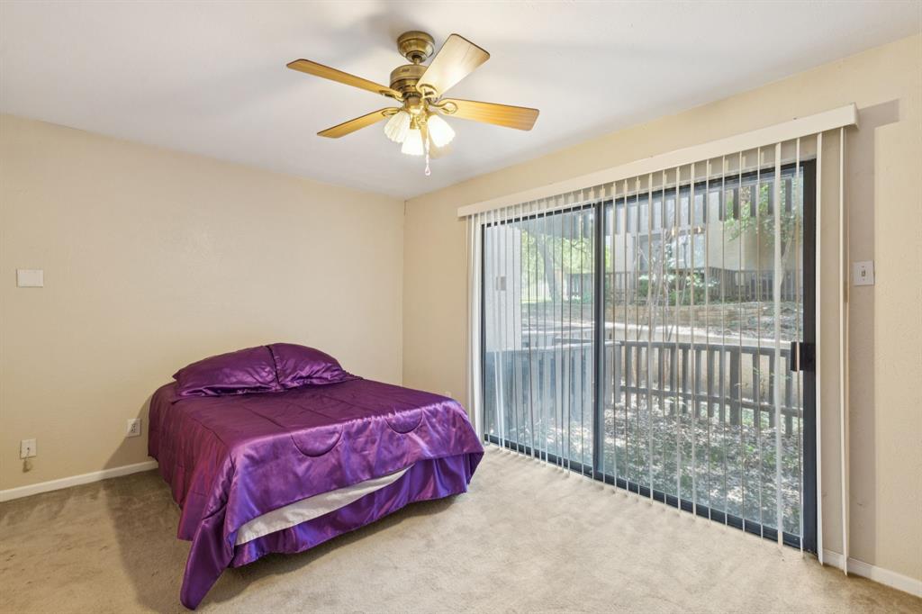 4569 North O'Connor Road, Unit 1320 Irving, TX 75062 - Photo 11 of 24 a bedroom with a bed and a chandelier