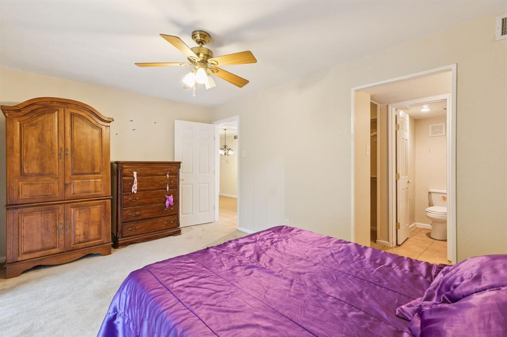 4569 North O'Connor Road, Unit 1320 Irving, TX 75062 - Photo 12 of 24 a bedroom with a bed and a chandelier