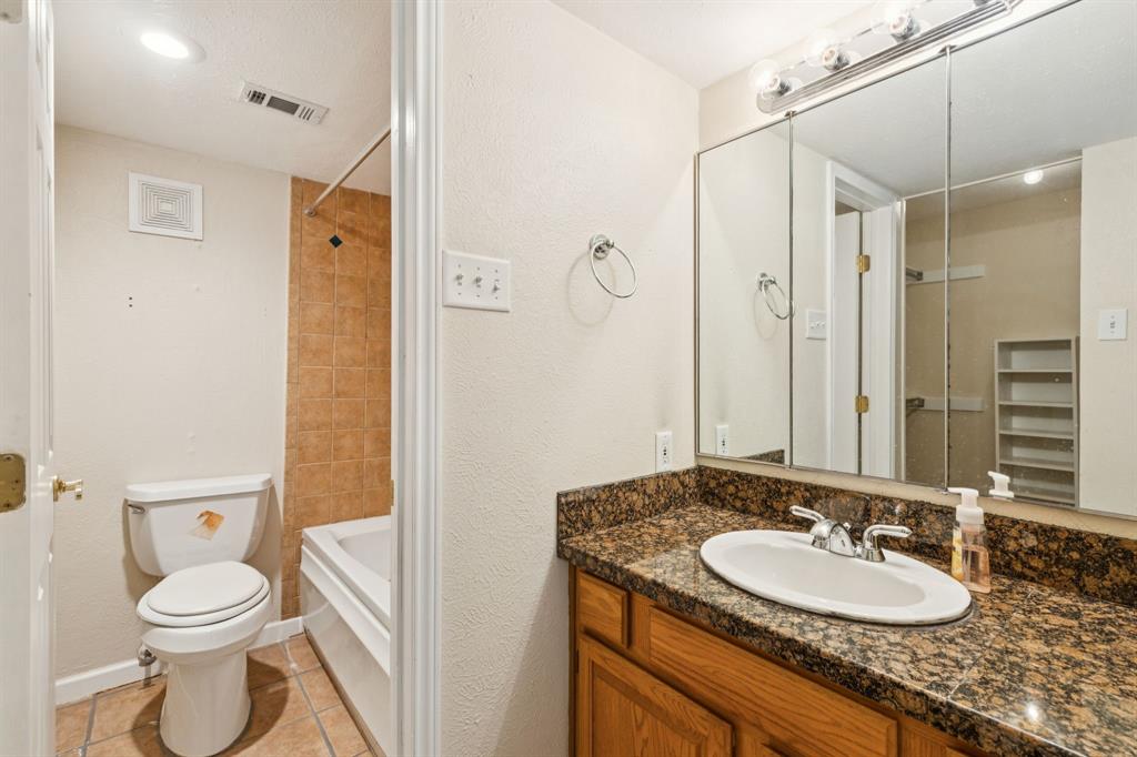 4569 North O'Connor Road, Unit 1320 Irving, TX 75062 - Photo 13 of 24 a bathroom with a granite countertop sink toilet and shower