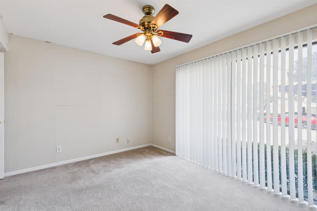 4569 North O'Connor Road, Unit 1320 Irving, TX 75062 - Photo 16 of 24 an empty room with a chandelier fan and windows