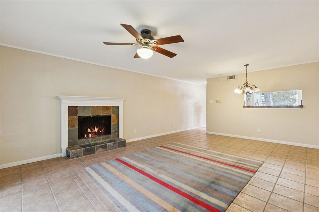 4569 North O'Connor Road, Unit 1320 Irving, TX 75062 - Photo 4 of 24 a view of an empty room with a fireplace and a window