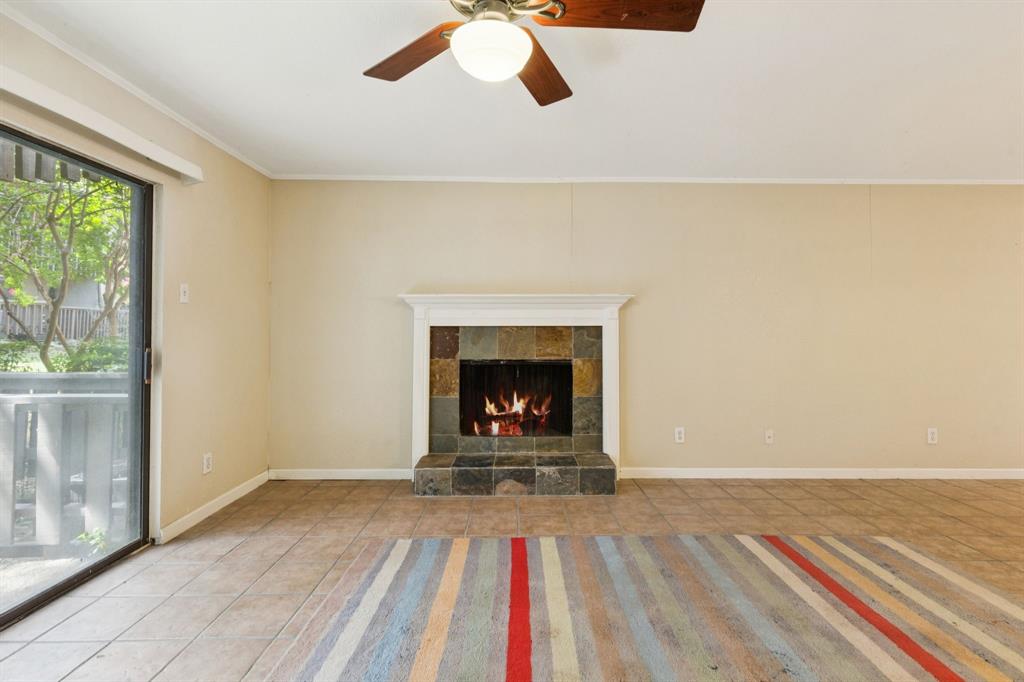 4569 North O'Connor Road, Unit 1320 Irving, TX 75062 - Photo 7 of 24 a view of a livingroom with a fireplace a rug and a large window