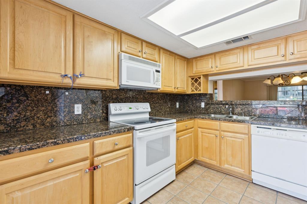 4569 North O'Connor Road, Unit 1320 Irving, TX 75062 - Photo 8 of 24 a kitchen with granite countertop cabinets stainless steel appliances and a counter space