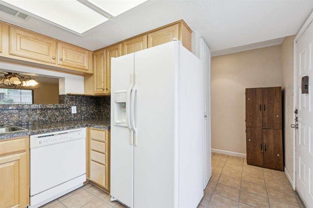 4569 North O'Connor Road, Unit 1320 Irving, TX 75062 - Photo 9 of 24 a kitchen with stainless steel appliances granite countertop a refrigerator and a stove