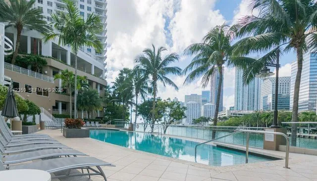 a view of swimming pool with outdoor seating and plants