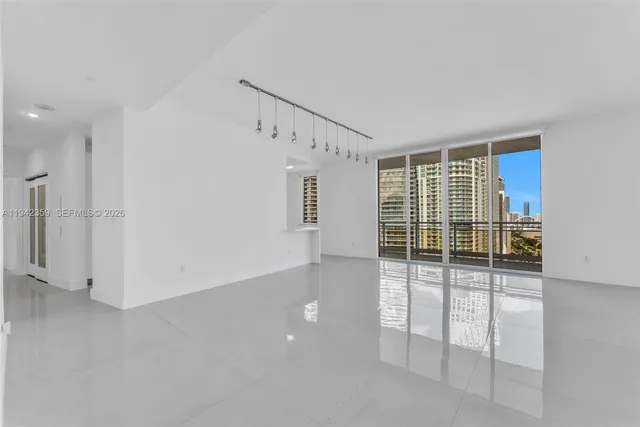a view of empty room with floor to ceiling window