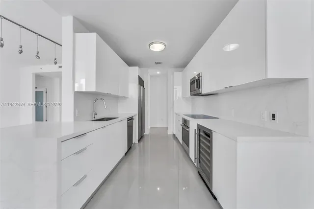 a kitchen with stainless steel appliances sink a microwave and cabinets