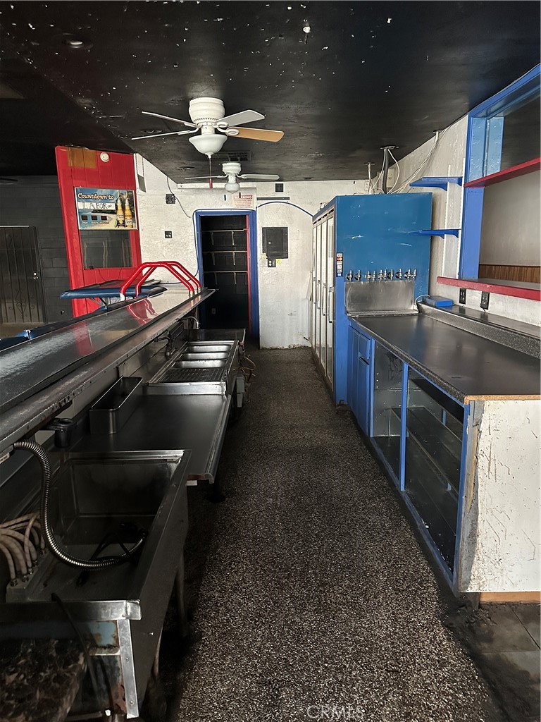 230 Fox Street Lemoore, CA 93245 - Photo 8 of 25 a kitchen with stainless steel appliances a stove a sink and a refrigerator