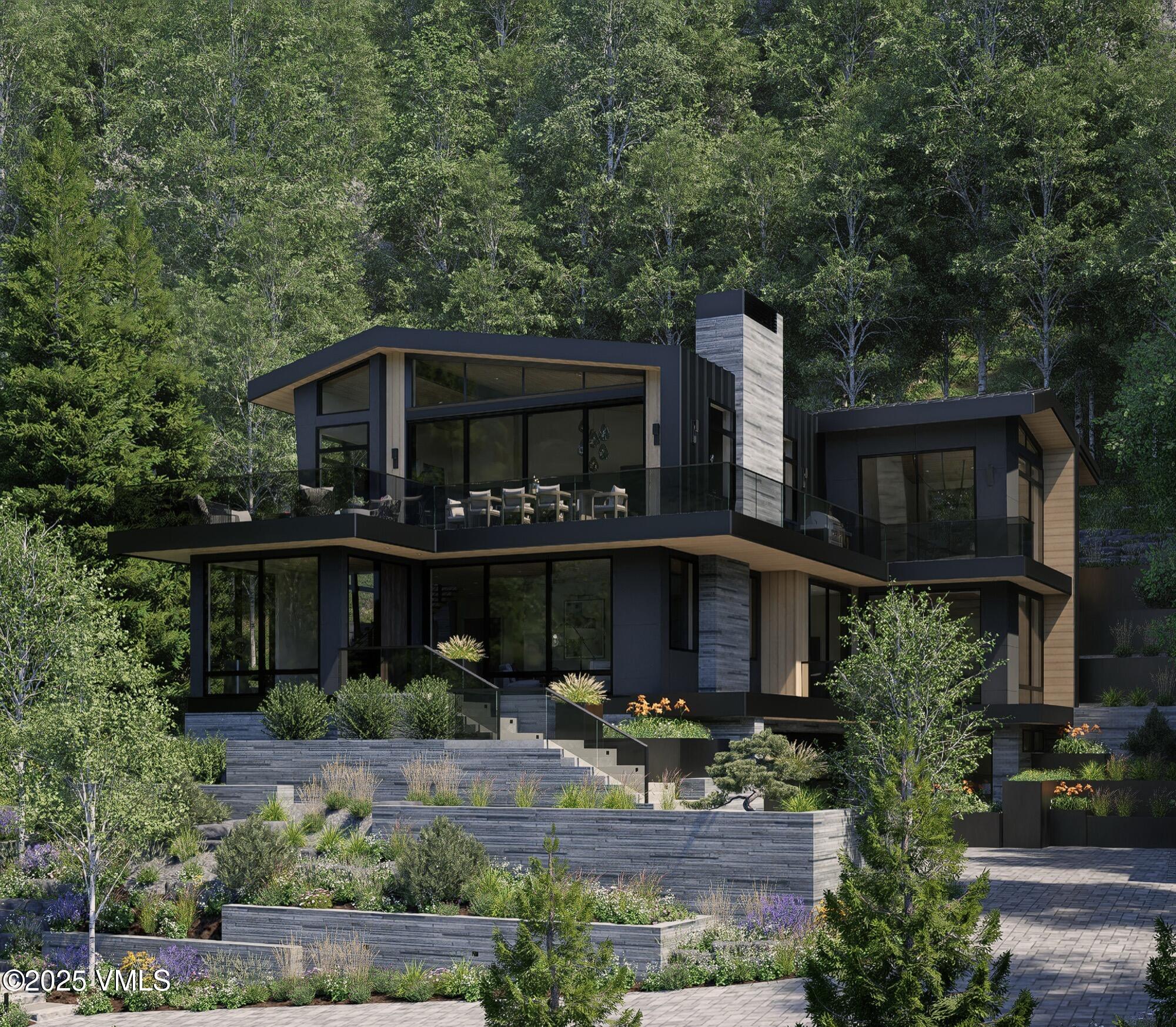 1150 Ptarmigan Road Vail, CO 81657 - Photo 2 of 36 a front view of a house with a garden