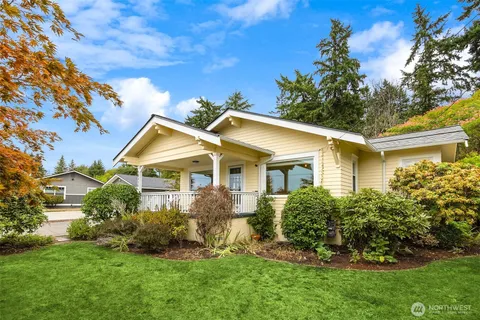 a view of a house with a big yard and potted plants