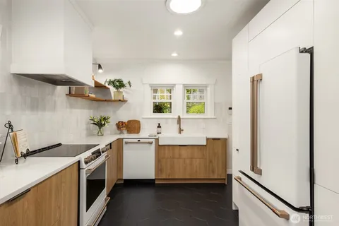 a kitchen with a sink stainless steel appliances and cabinets