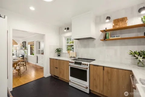 a kitchen with a stove and white cabinets