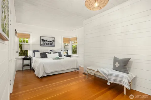 a bedroom with a bed and a chair