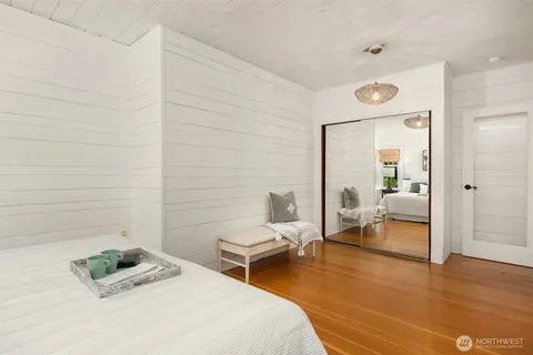 a bedroom with a bed and a couch