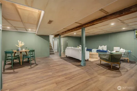 a bedroom with furniture and a wooden floor