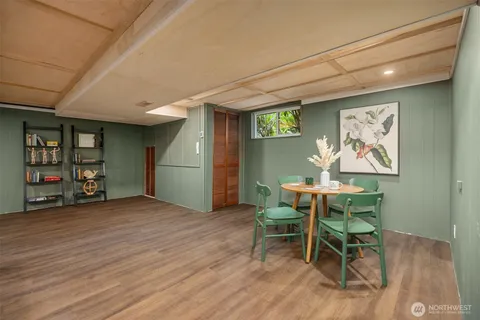 a view of a room with furniture and wooden floor