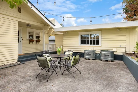 a view of a house with patio and a yard