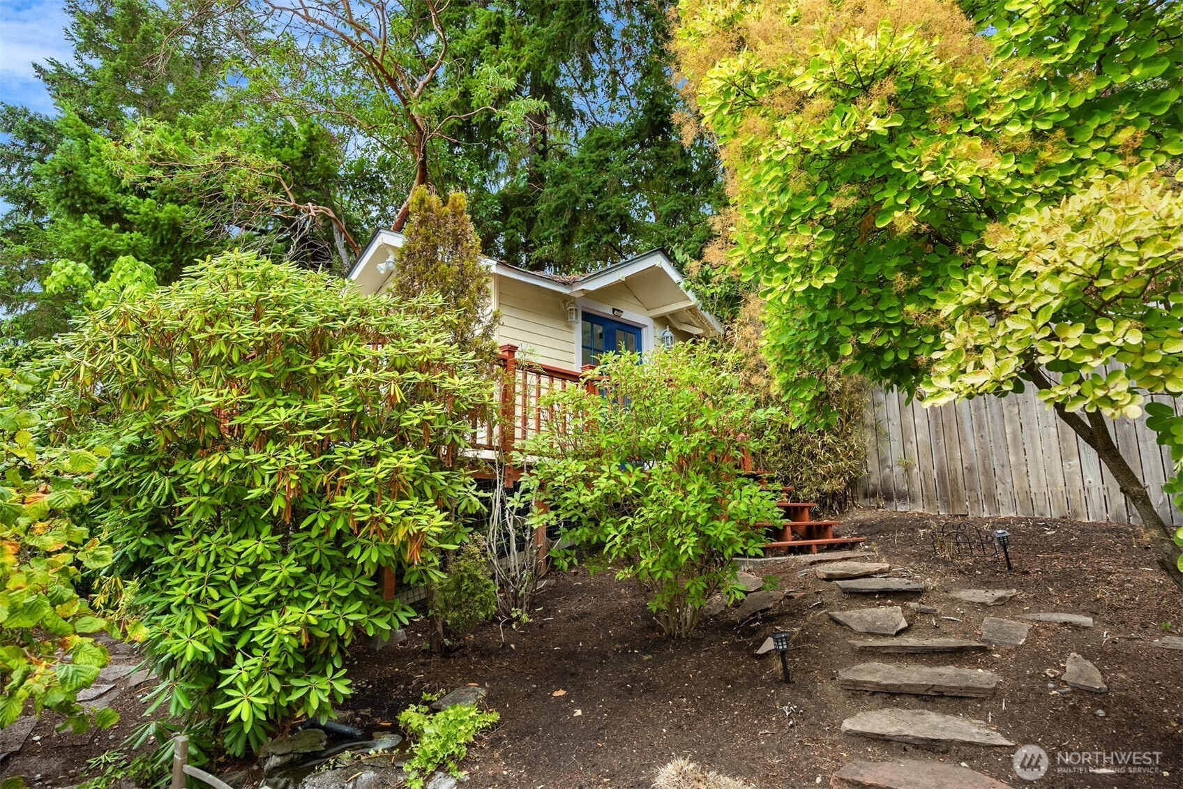 18330 9th Avenue Northeast Poulsbo, WA 98370 - Photo 26 of 32 a view of a wooden house with a yard and plants
