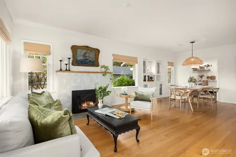 a living room with furniture a table and a fireplace