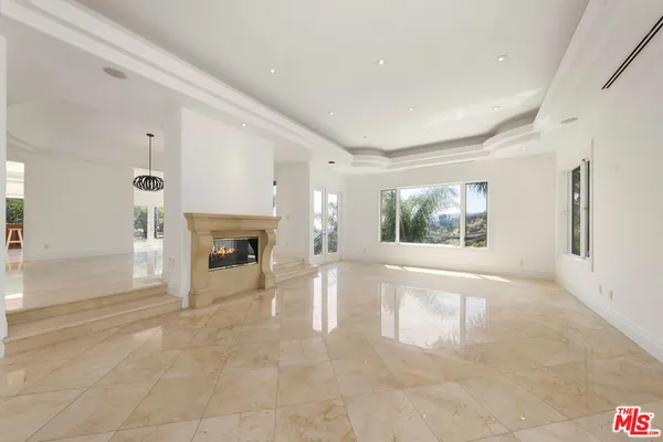 a view of empty room with a fireplace
