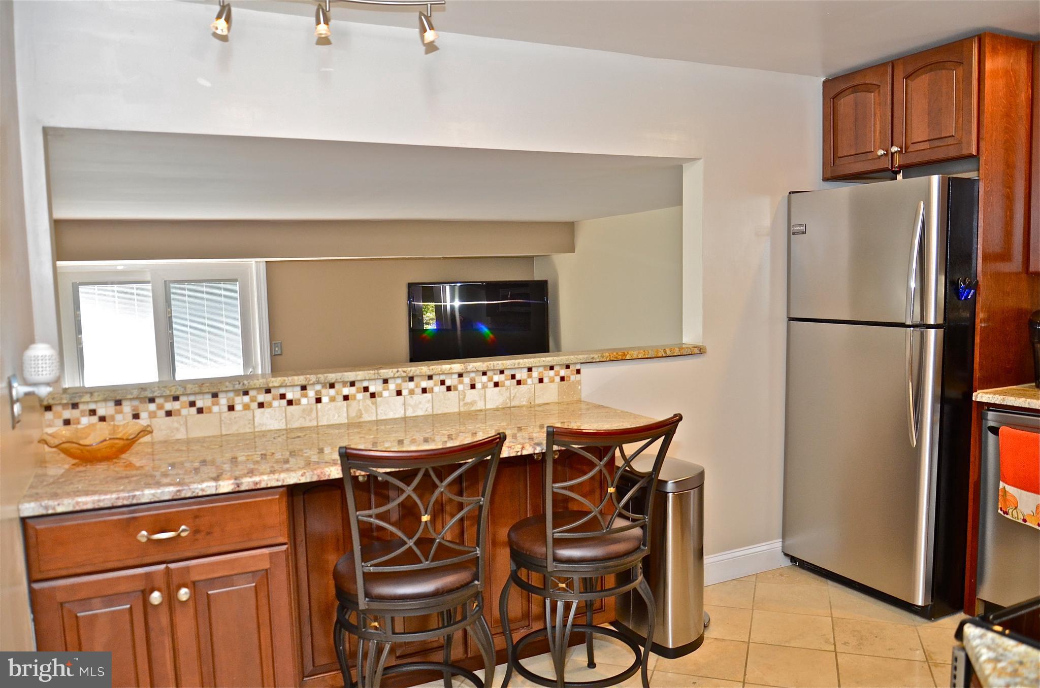 9229 Bowline Road Baltimore, MD 21236 - Photo 12 of 24 a kitchen with a refrigerator a stove and a sink