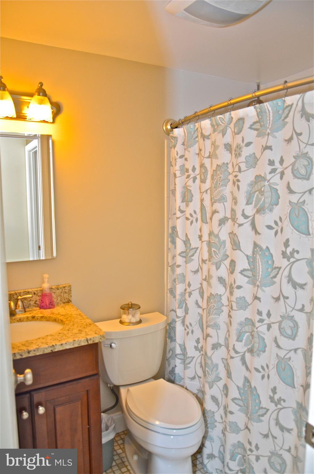 9229 Bowline Road Baltimore, MD 21236 - Photo 19 of 24 a bathroom with a granite countertop toilet and a sink