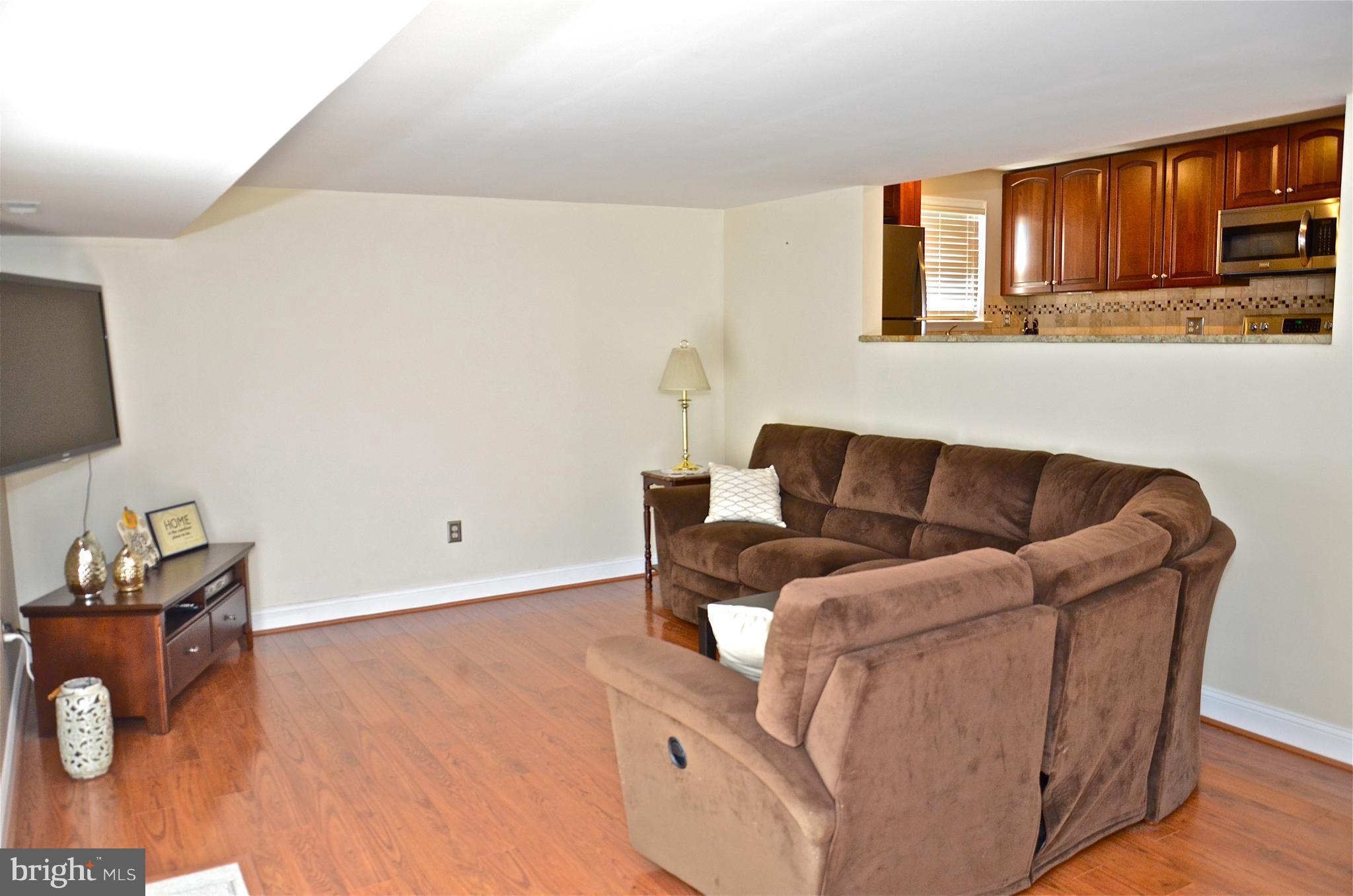 9229 Bowline Road Baltimore, MD 21236 - Photo 20 of 24 a living room with furniture and a flat screen tv
