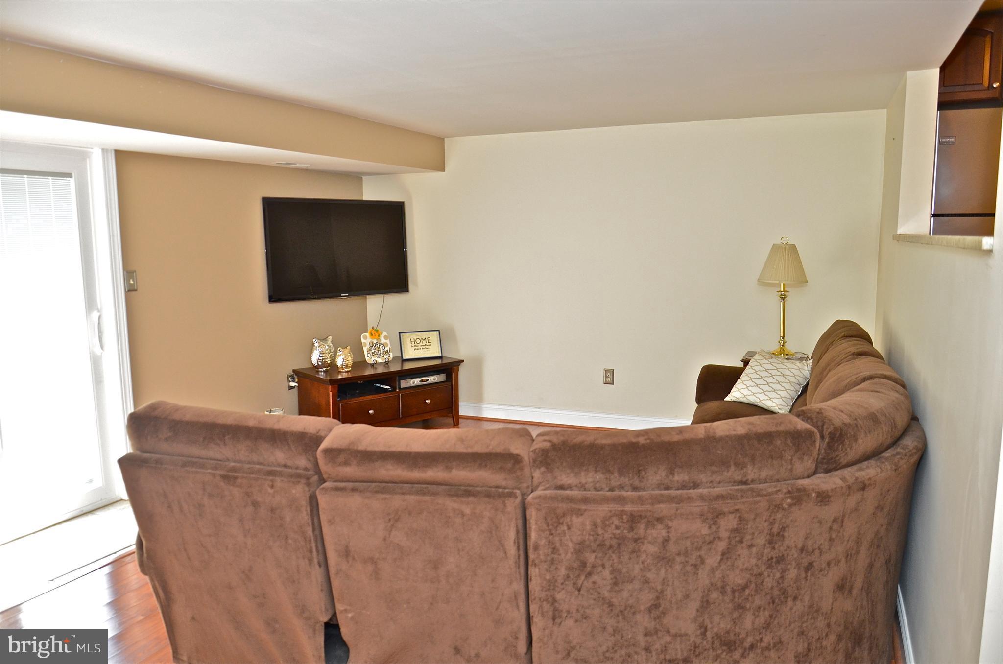 9229 Bowline Road Baltimore, MD 21236 - Photo 22 of 24 a living room with furniture and a flat screen tv