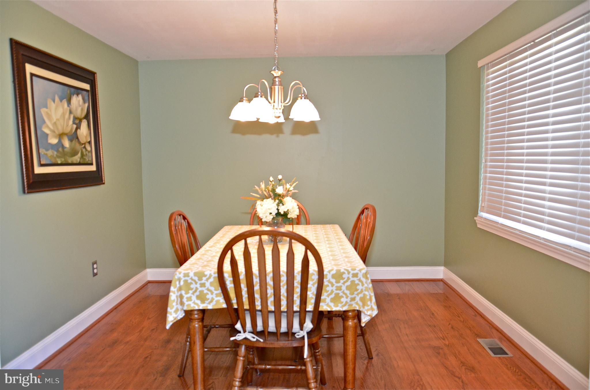 9229 Bowline Road Baltimore, MD 21236 - Photo 4 of 24 a view of a dining room with furniture wooden floor and chandelier