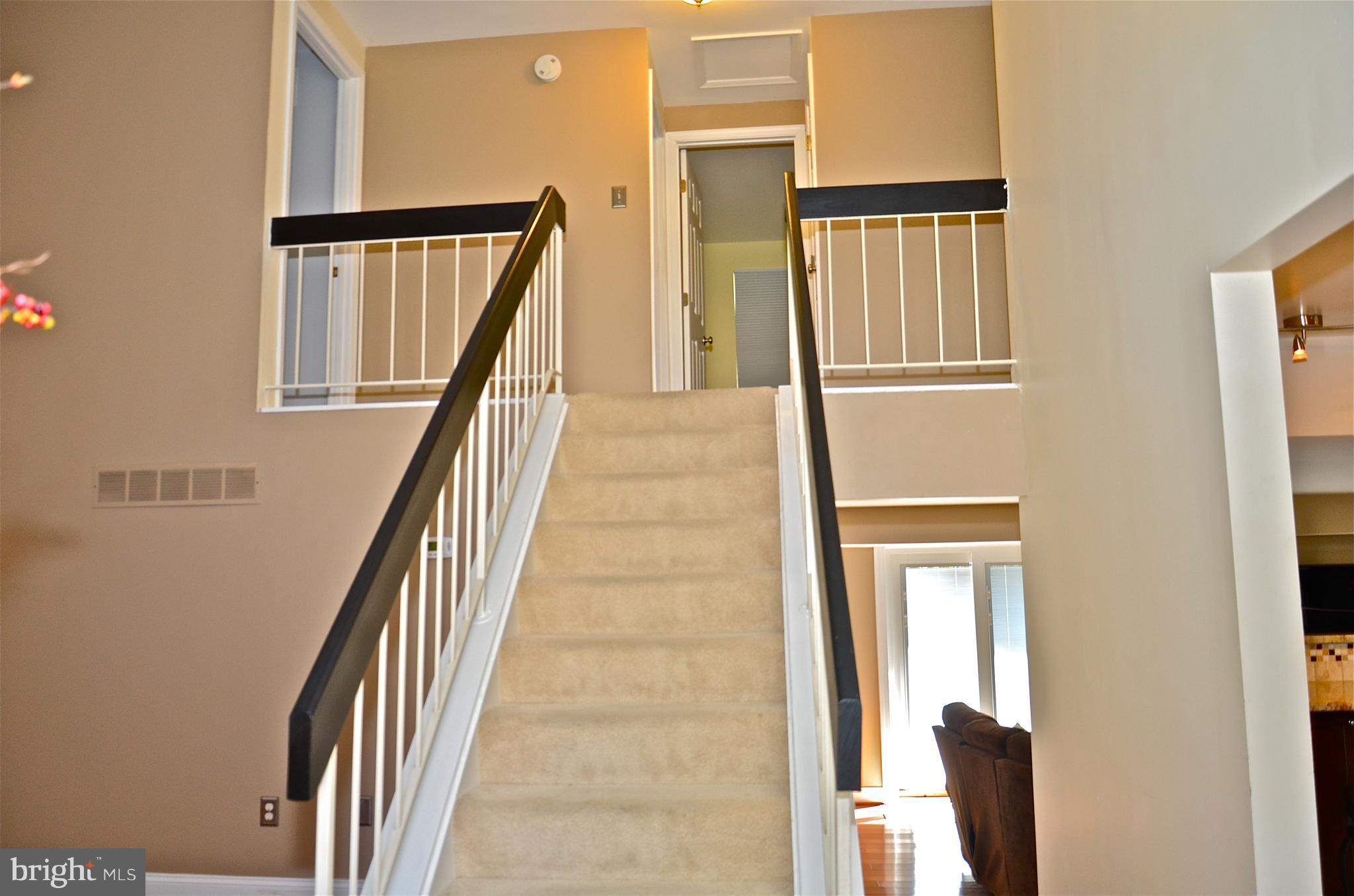 9229 Bowline Road Baltimore, MD 21236 - Photo 7 of 24 a view of staircase with white walls and a window