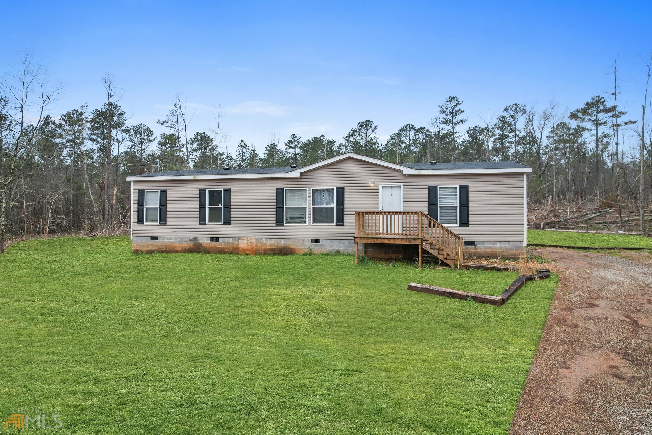 a view of a house with a backyard and a patio