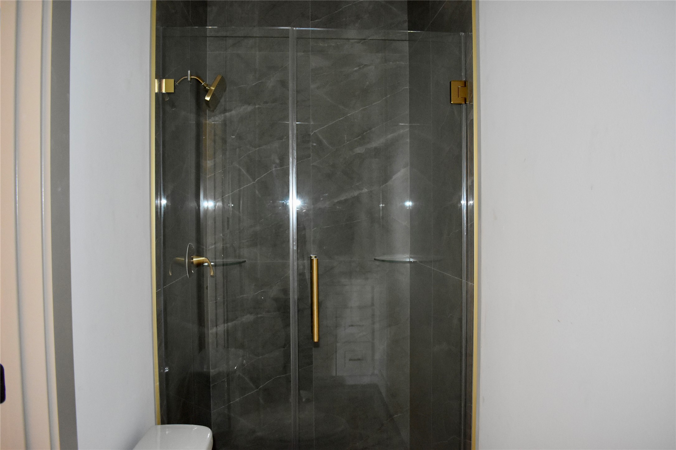 9803 Bucroft Street Houston, TX 77029 - Photo 6 of 7 a bathroom with a glass shower door
