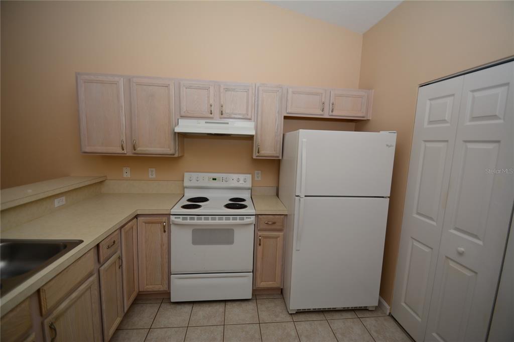 37 Eton Lane, Unit A Palm Coast, FL 32164 - Photo 12 of 34 a kitchen with a stove a refrigerator and a sink